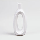 Minimalist white glossy vase featuring a unique hollow shape

