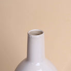 Decorative white vase with a smooth glossy finish

