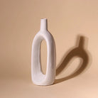 Sculptural white glossy vase for contemporary interiors

