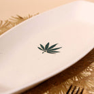 Decorative white ceramic platter with leaf design

